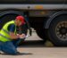 truck driver inspecting tires safety check